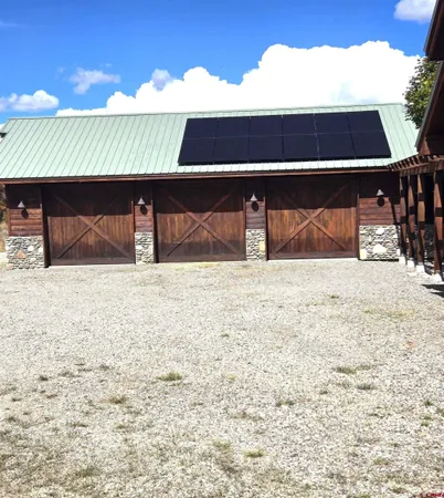 a kitchen with stainless steel appliances granite countertop a stove and a wooden floors