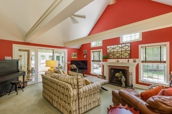 595 Bay Road Hamilton, MA 01982 - Photo 7 of 30 a living room with furniture a flat screen tv and a fireplace