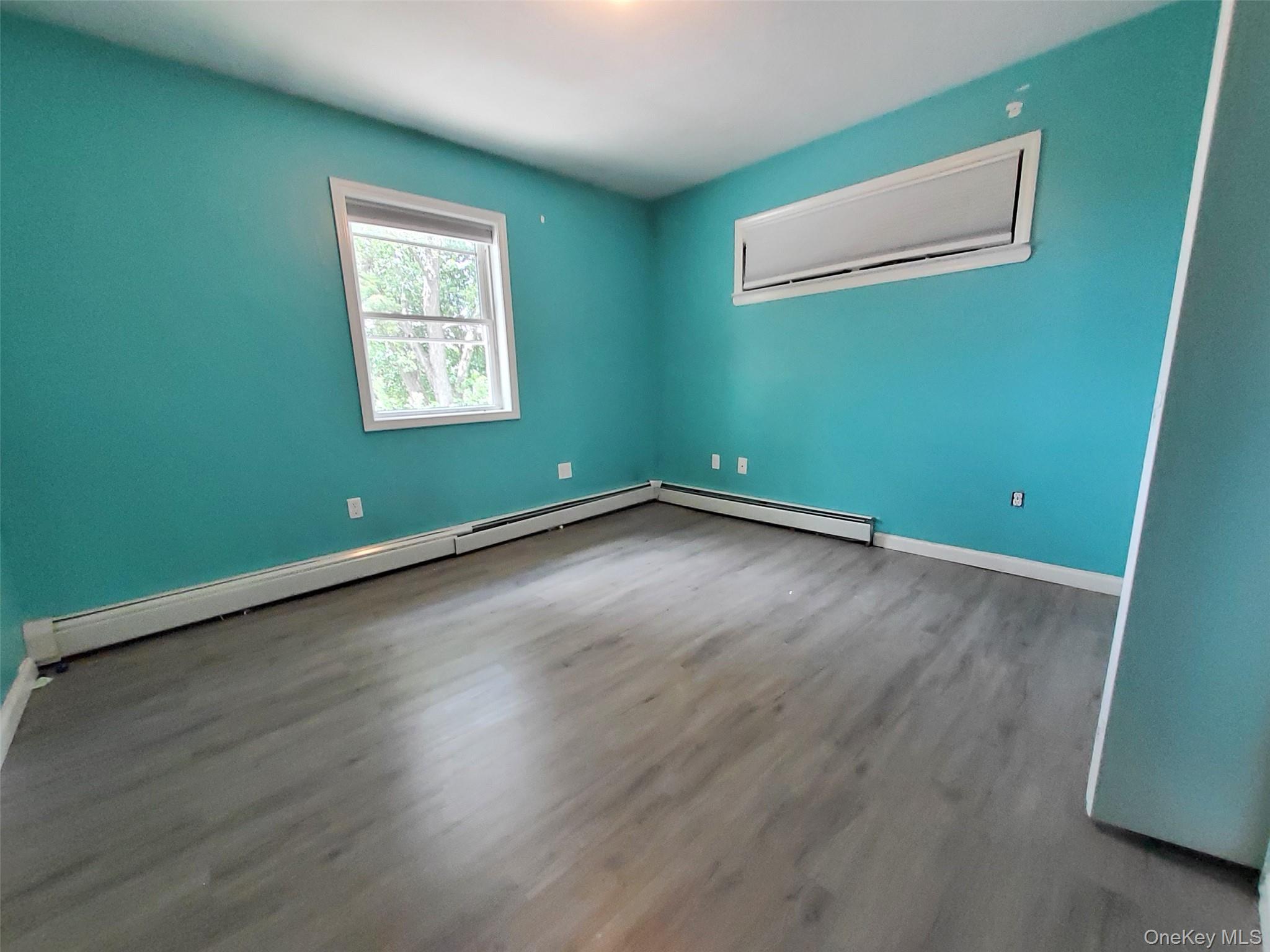 469 Hillside Road Monroe, NY 10950 - Photo 7 of 20 an empty room with wooden floor and windows