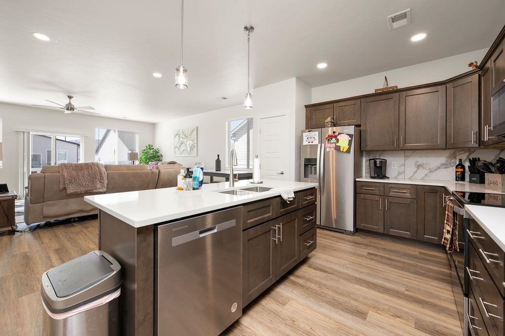 1694 Tungsten Way Fruita, CO 81521 - Photo 11 of 22 a kitchen with a sink a counter top space a large window and stainless steel appliances