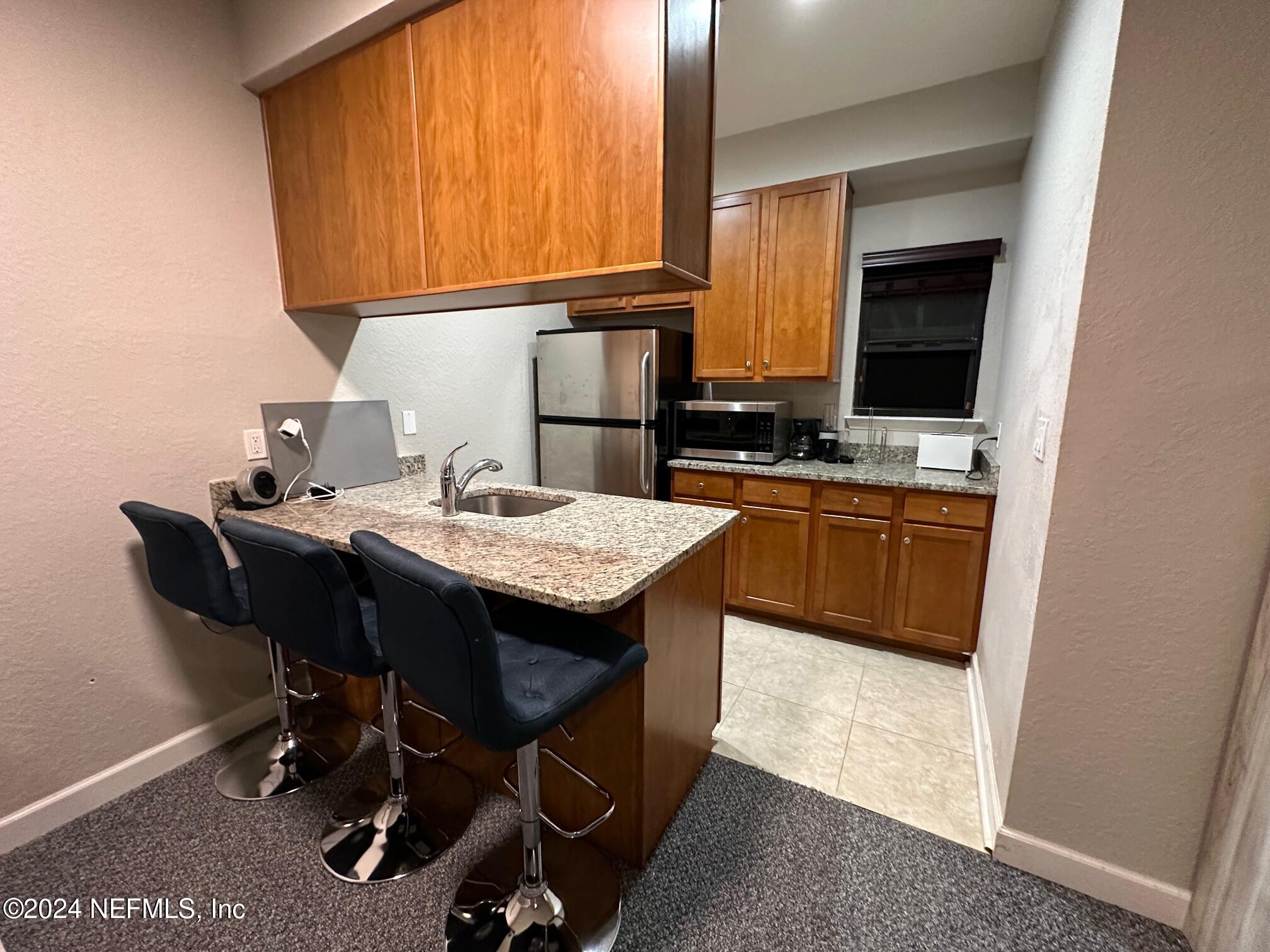 634 Market Street St. Augustine, FL 32095 - Photo 4 of 8 a kitchen with a sink a table and chairs