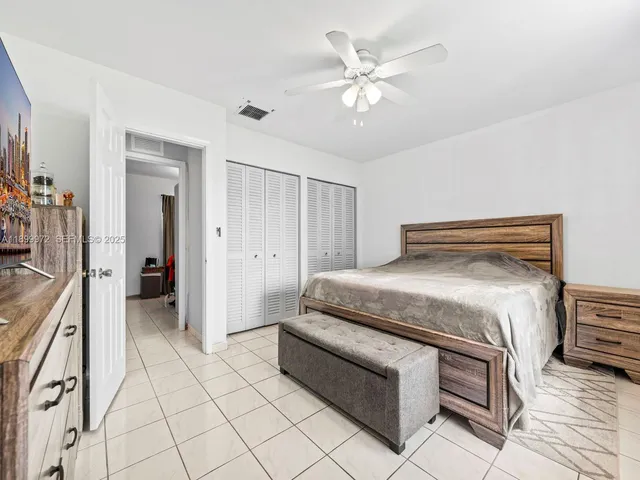 a spacious bedroom with a bed and a chandelier