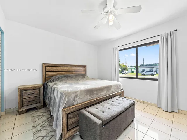 a bedroom with a bed a rug and a window