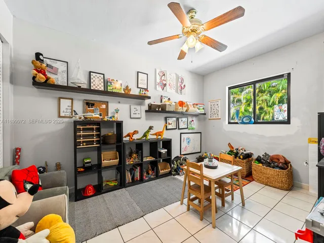 a living room with lots of furniture and baby bed