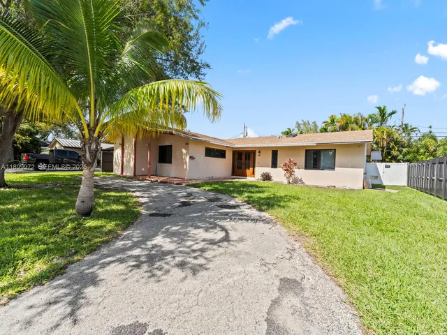 a view of a patio with table and chairs and potted plants