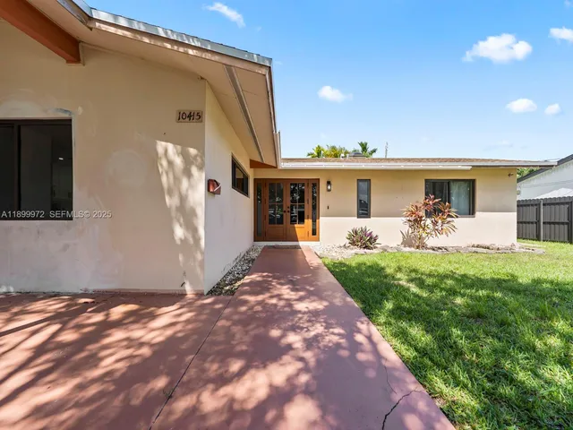 a view of a backyard with potted plants