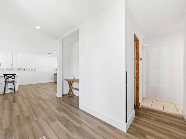 a view of empty room with wooden floor