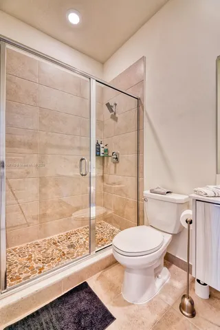 a bathroom with a toilet and a shower