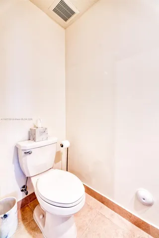 a white toilet sitting next to a bathroom sink