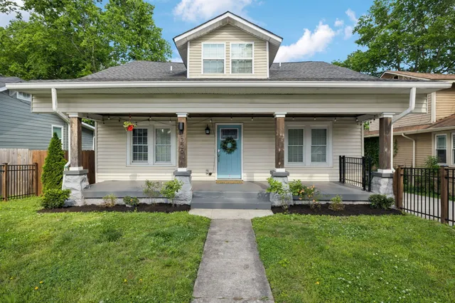 a front view of a house with a yard and outdoor seating