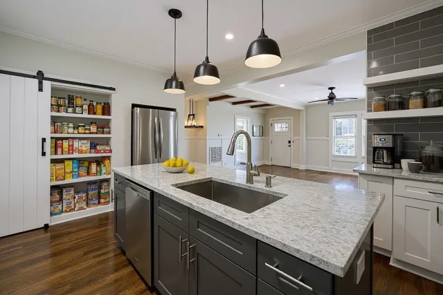 a stove top oven sitting inside of a kitchen