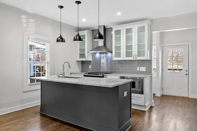 a view of a workspace with furniture and wooden floor