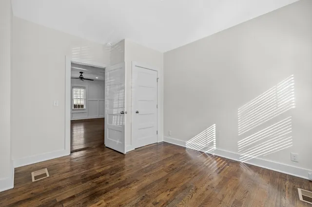 a bedroom with a bed and a couch next to a window