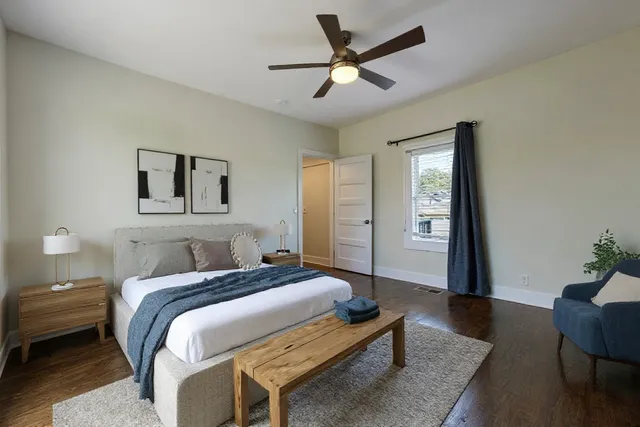 a bedroom with a bed and a window