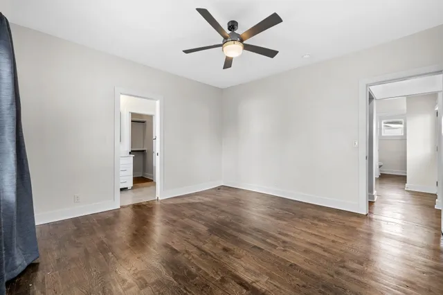 an empty room with wooden floor and closet
