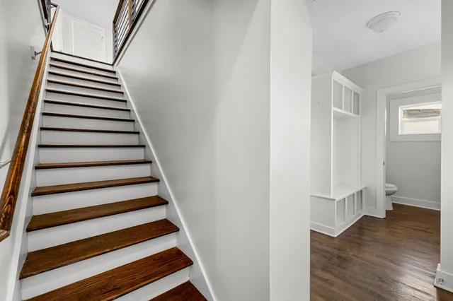 a bathroom with a granite countertop sink mirror and a toilet