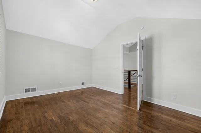 a view of backyard with table and chairs and a large tree
