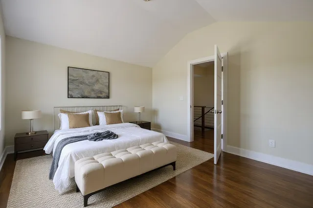 a view of a backyard with a fence and a large tree