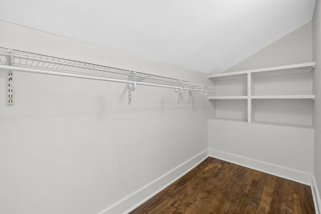 a view of a white house with large windows and a small yard