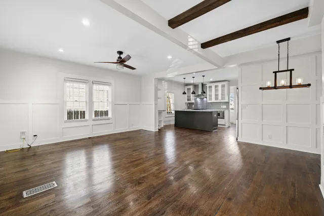 a living room with fireplace furniture and a wooden floor