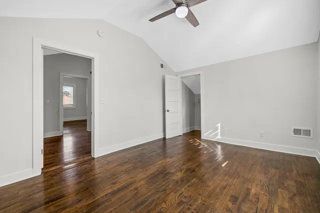 an aerial view of residential houses with outdoor space and trees