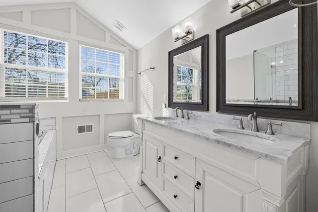 an aerial view of residential houses with outdoor space and river