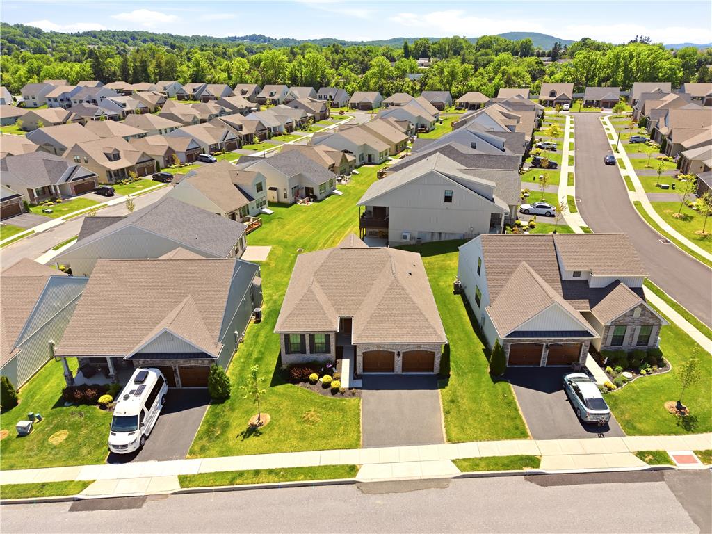 4120 Eveningstar Road Emmaus, PA 18049 - Photo 53 of 62 An aerial perspective reveals a harmonious suburban development nestled against a scenic tree-lined landscape.