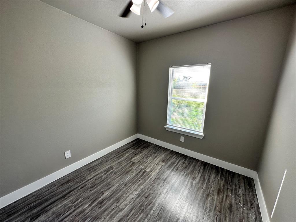 500 Como Street South Sulphur Springs, TX 75482 - Photo 22 of 27 a view of an empty room with wooden floor and a window