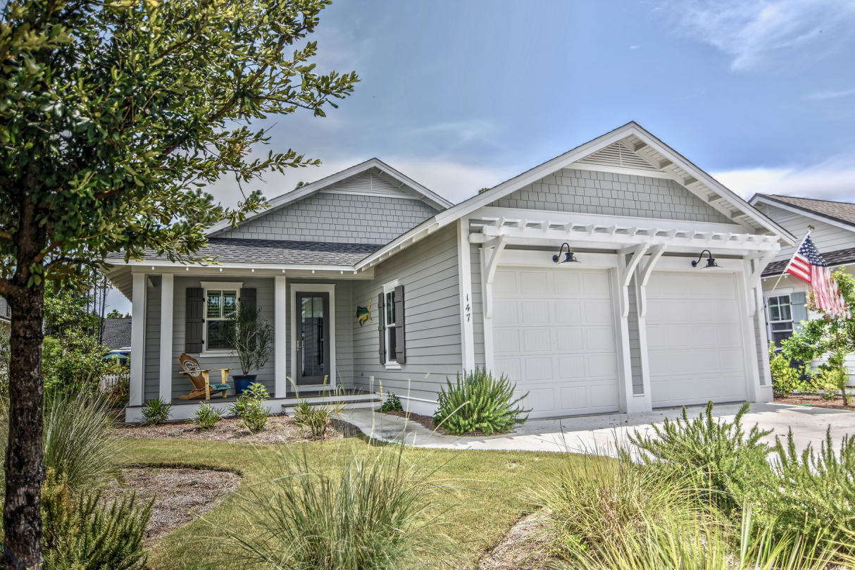 a view of a house with backyard and sitting area
