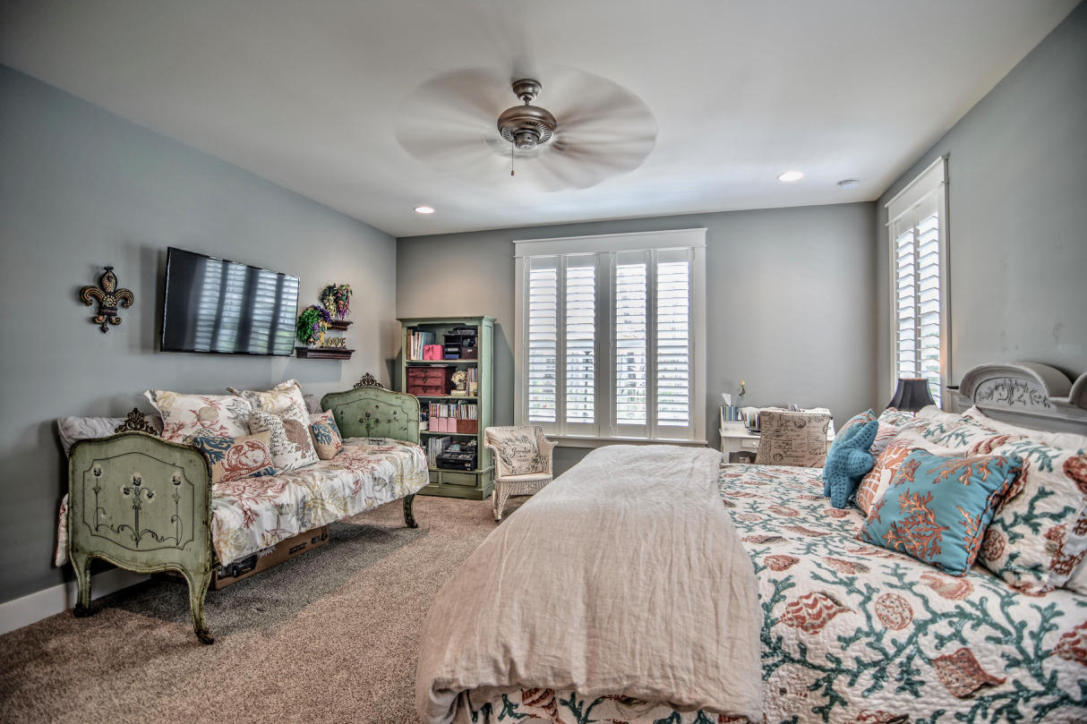 147 Jack Knife Drive Watersound, FL 32461 - Photo 11 of 42 a bedroom with a bed and a chandelier