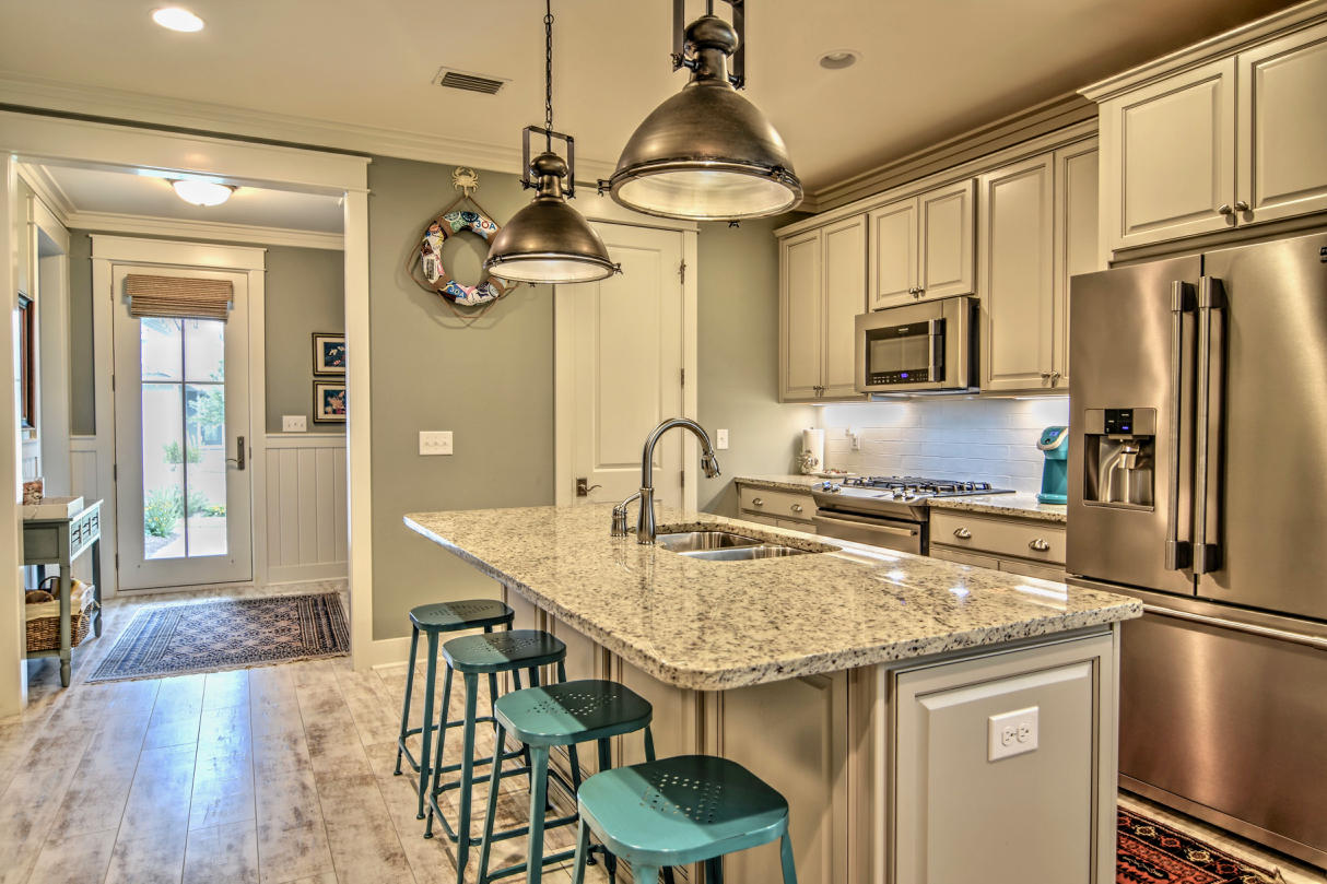147 Jack Knife Drive Watersound, FL 32461 - Photo 3 of 42 a kitchen with stainless steel appliances granite countertop a sink refrigerator and cabinets