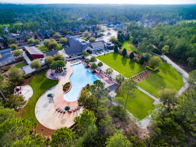 147 Jack Knife Drive Watersound, FL 32461 - Photo 30 of 42 an aerial view of a house with a swimming pool yard and mountain view in back