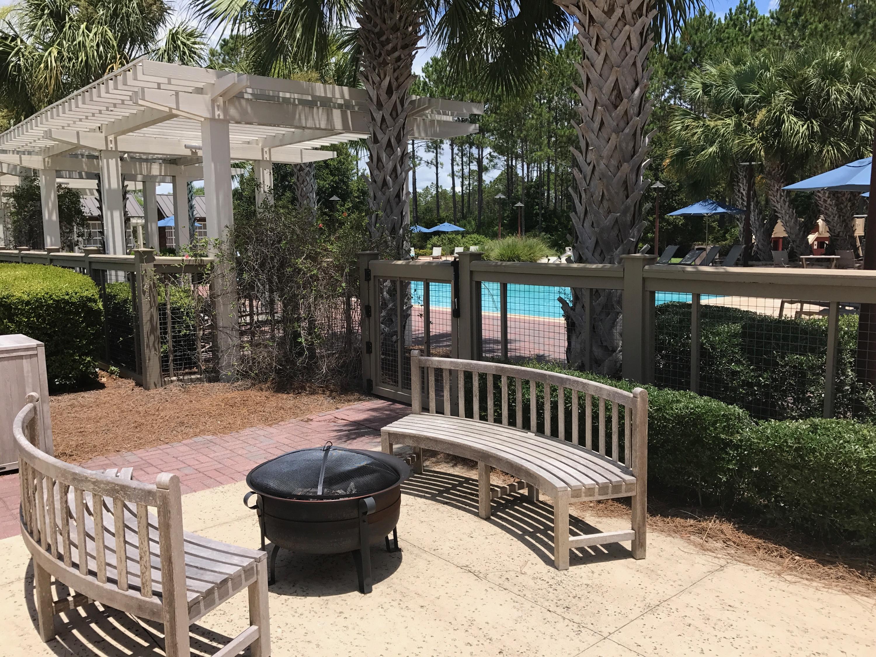 147 Jack Knife Drive Watersound, FL 32461 - Photo 39 of 42 a view of a patio with a table and chairs and potted plants