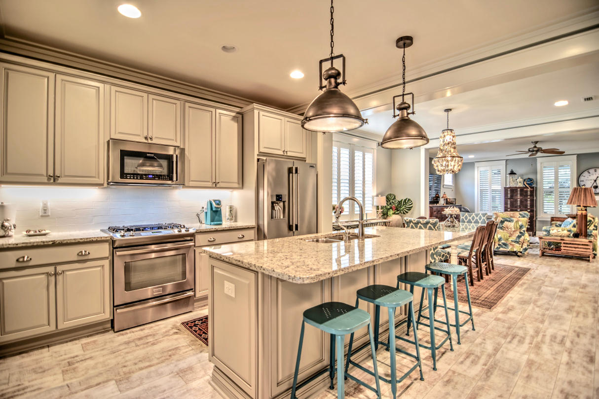 147 Jack Knife Drive Watersound, FL 32461 - Photo 4 of 42 a large kitchen with granite countertop lots of white cabinets stainless steel appliances and a island