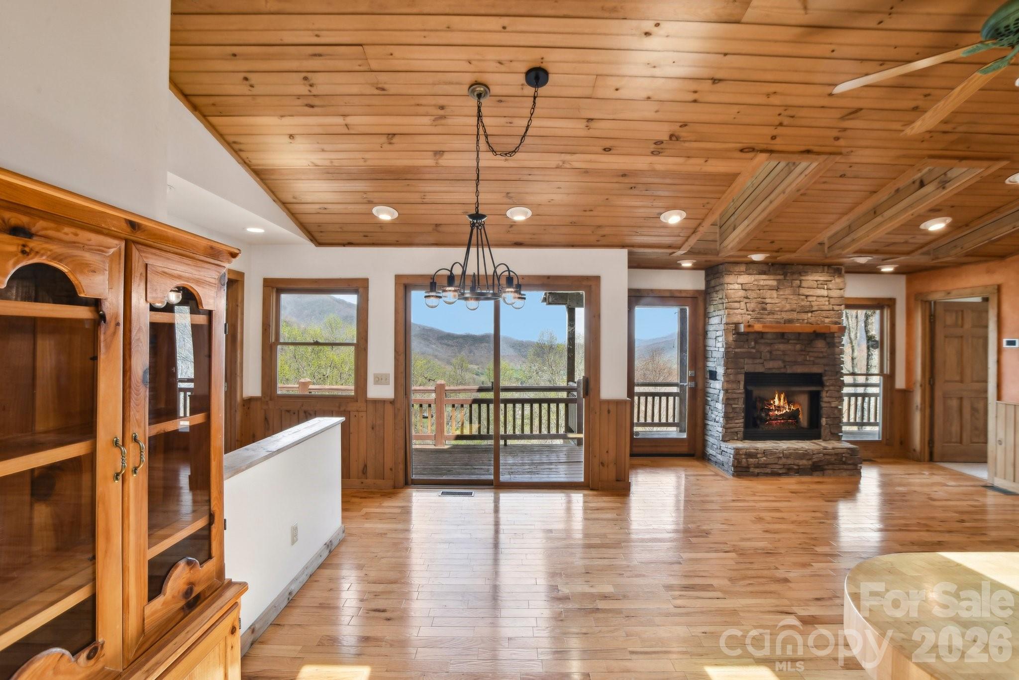 1426 Setzercove Road Maggie Valley, NC 28751 - Photo 12 of 48 a view of a hall with wooden floor and a fireplace