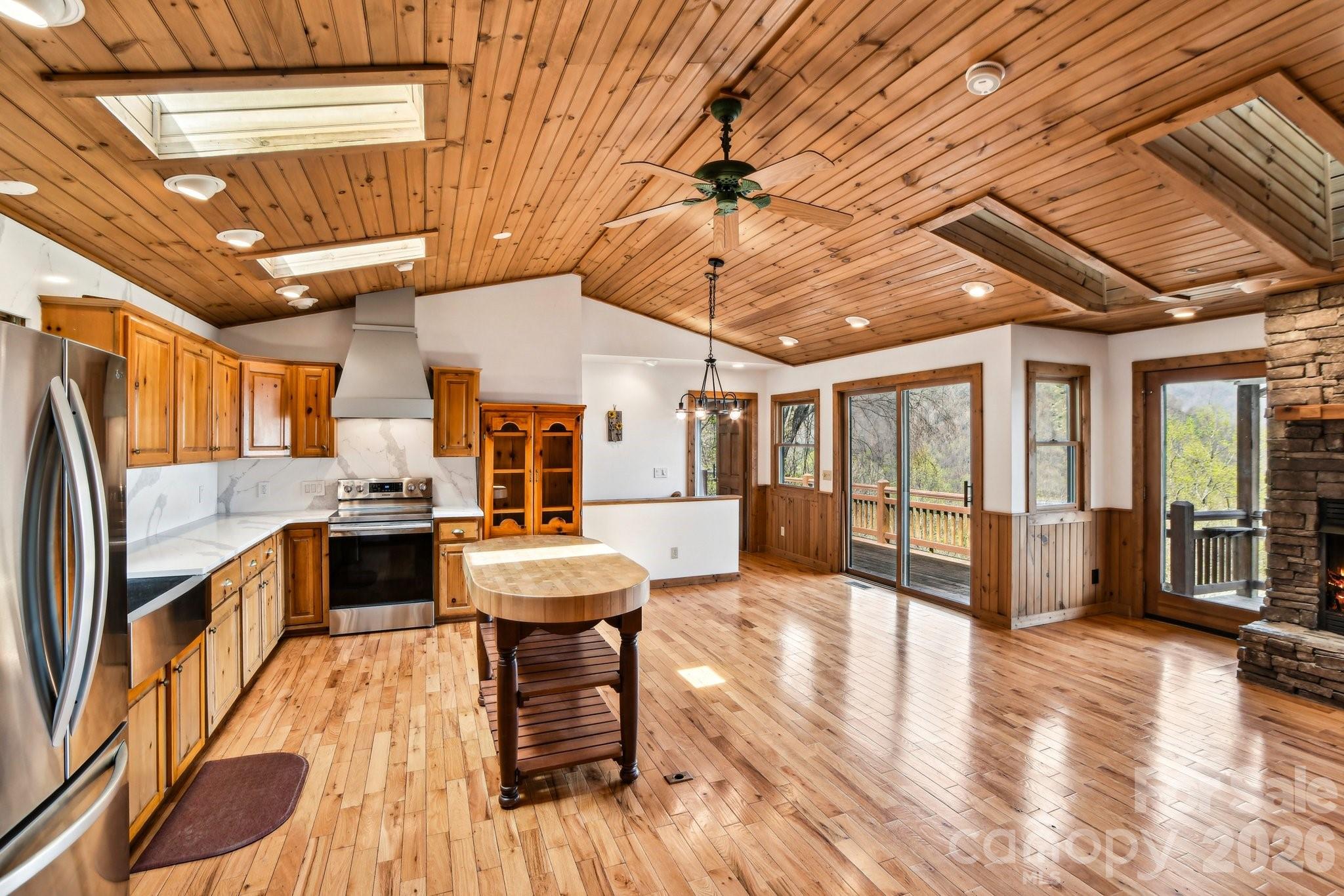 1426 Setzercove Road Maggie Valley, NC 28751 - Photo 13 of 48 a view of a dining room with furniture window and wooden floor