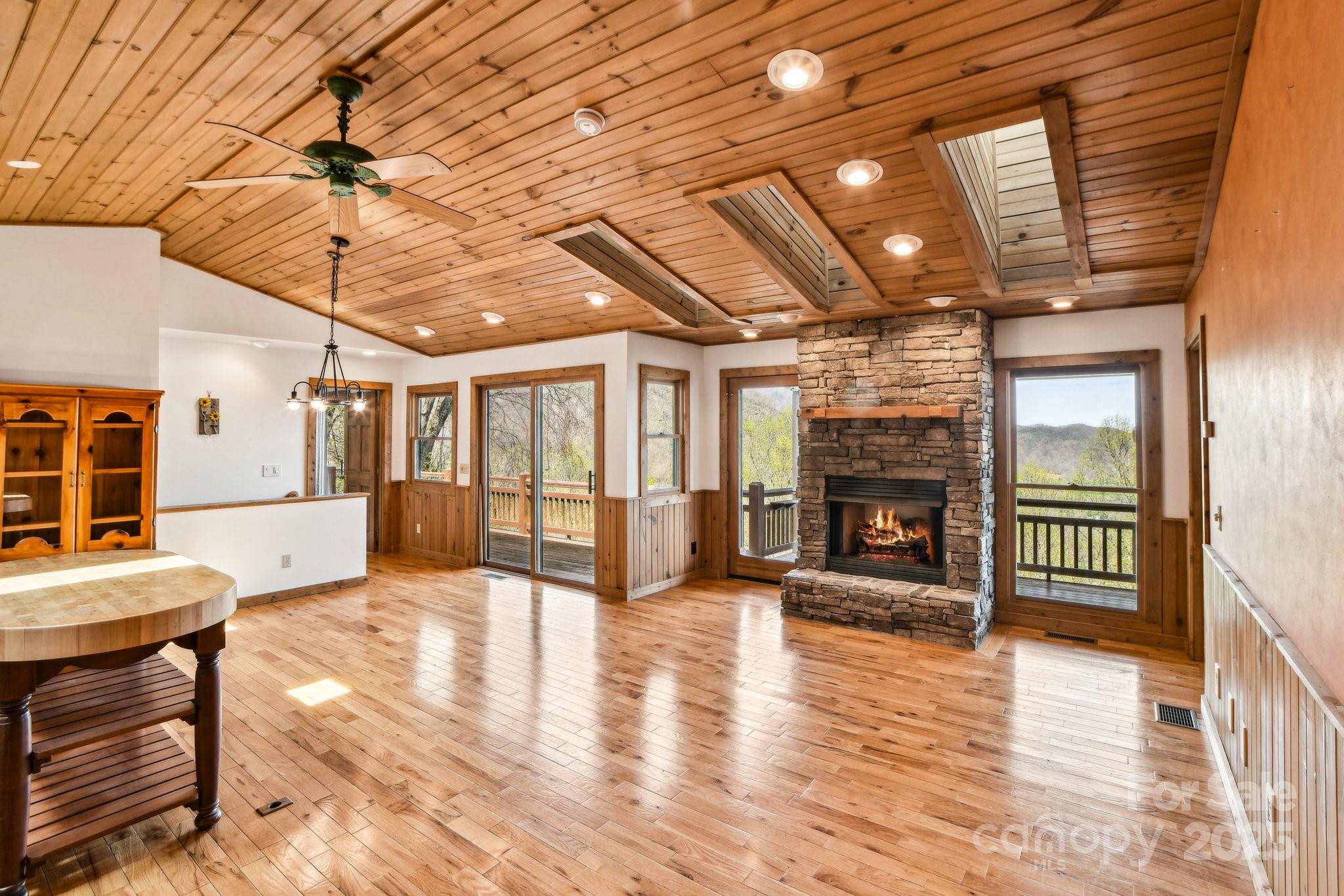 1426 Setzercove Road Maggie Valley, NC 28751 - Photo 14 of 48 a view of a livingroom with furniture a fireplace and wooden floor