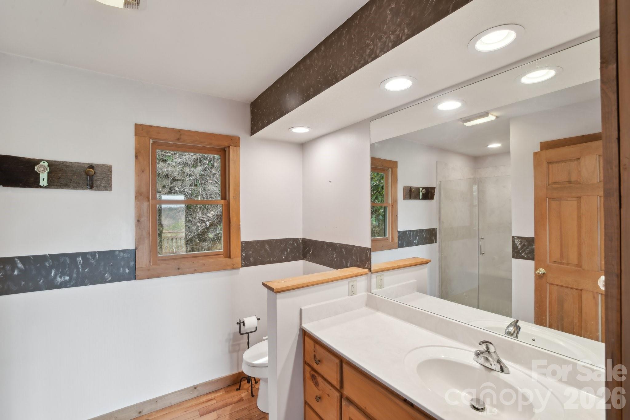 1426 Setzercove Road Maggie Valley, NC 28751 - Photo 20 of 48 a spacious bathroom with a bathtub sink and mirror