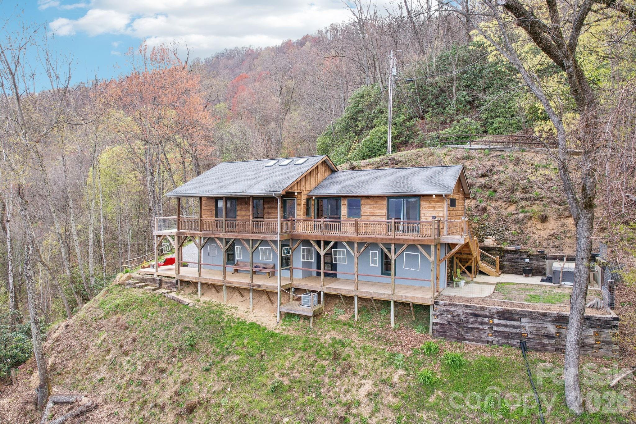 1426 Setzercove Road Maggie Valley, NC 28751 - Photo 2 of 48 a backyard of a house with yard and outdoor seating