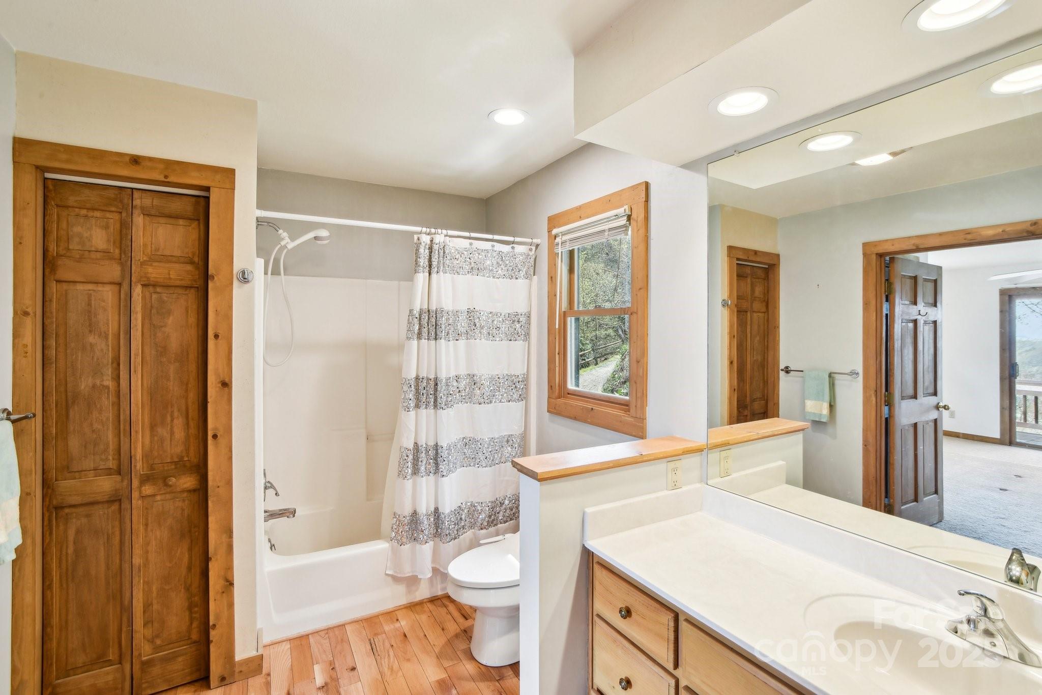 1426 Setzercove Road Maggie Valley, NC 28751 - Photo 21 of 48 a bathroom with a sink toilet and shower