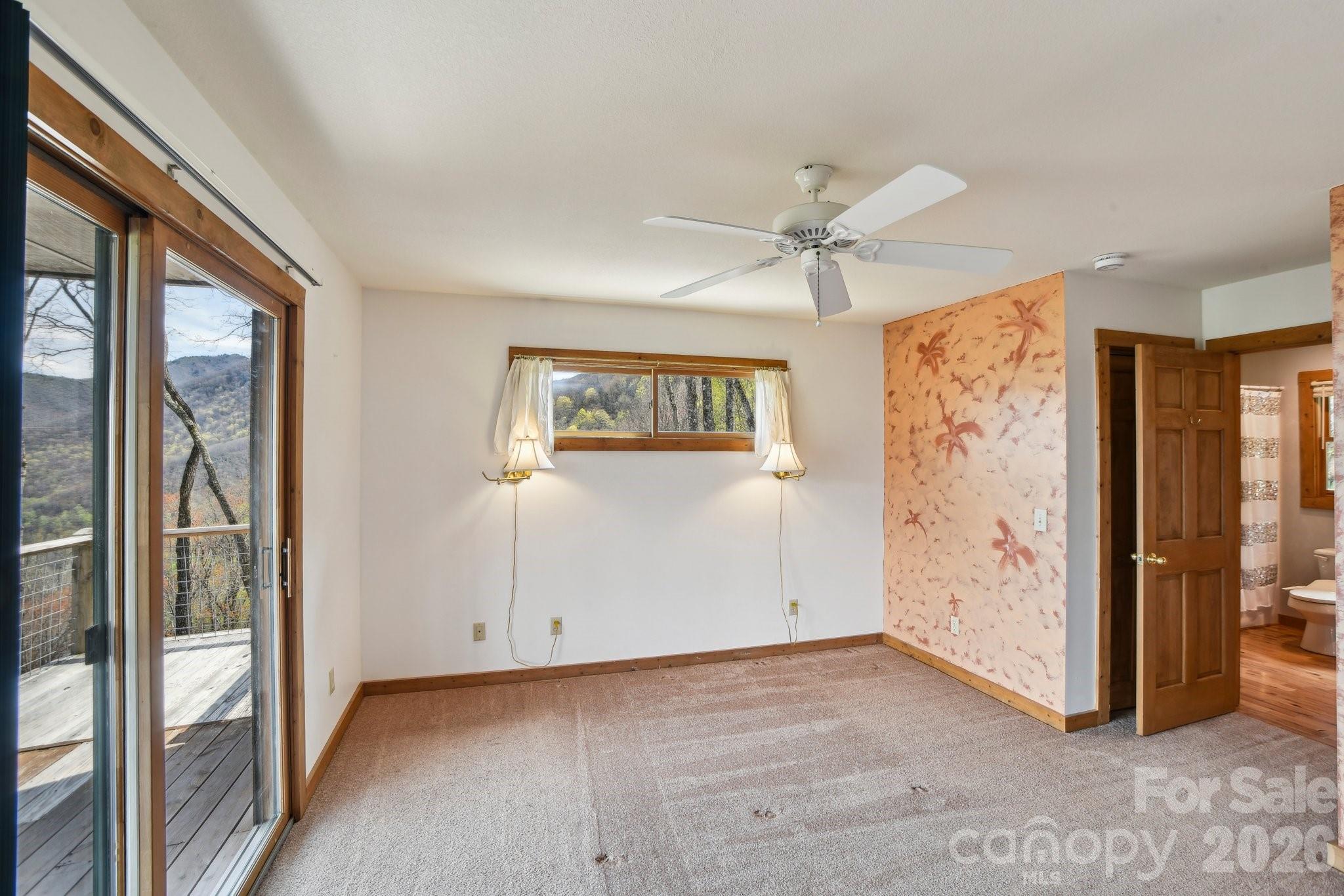 1426 Setzercove Road Maggie Valley, NC 28751 - Photo 21 of 48 a view of a livingroom with a ceiling fan and window