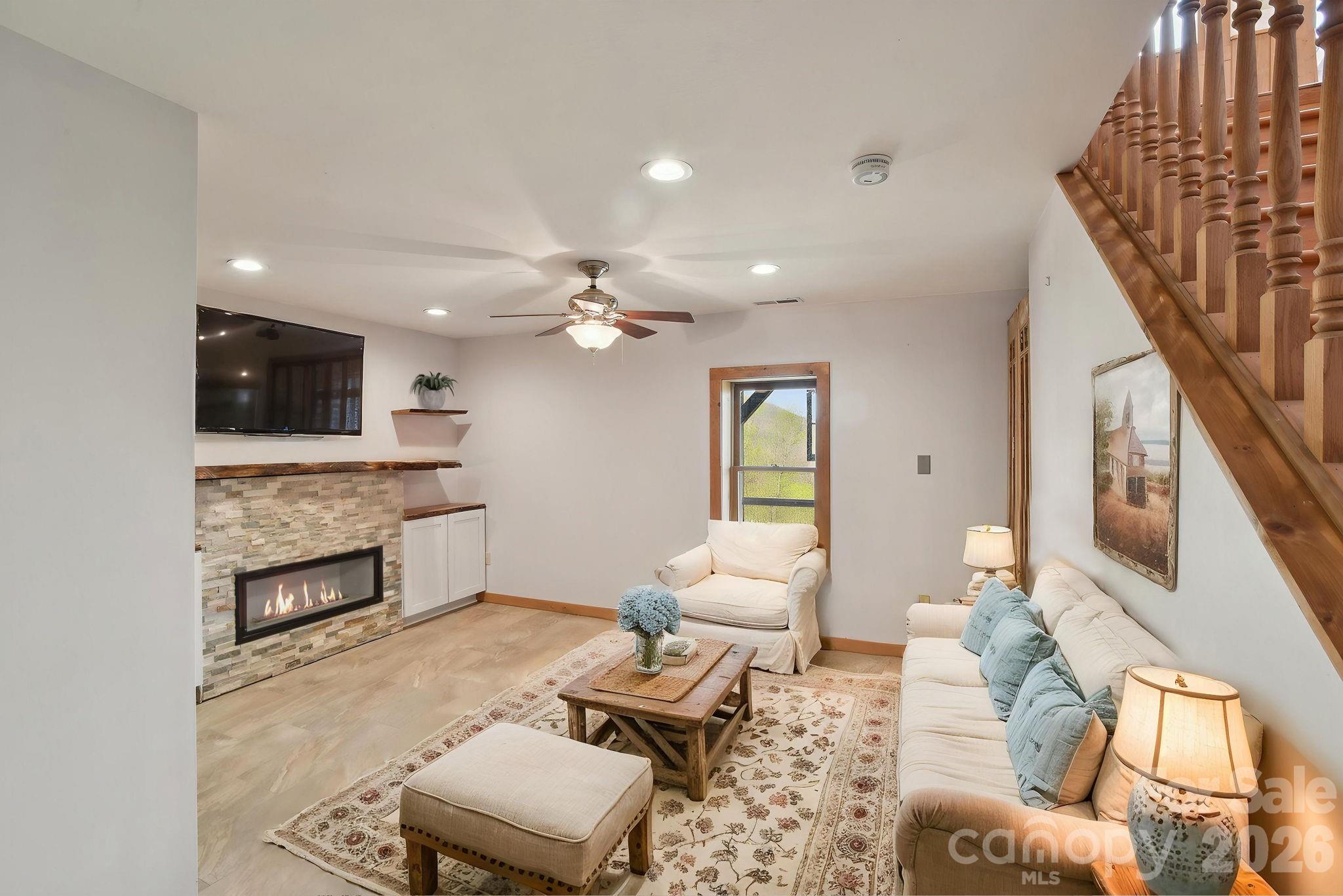 1426 Setzercove Road Maggie Valley, NC 28751 - Photo 27 of 48 a living room with furniture and a fireplace