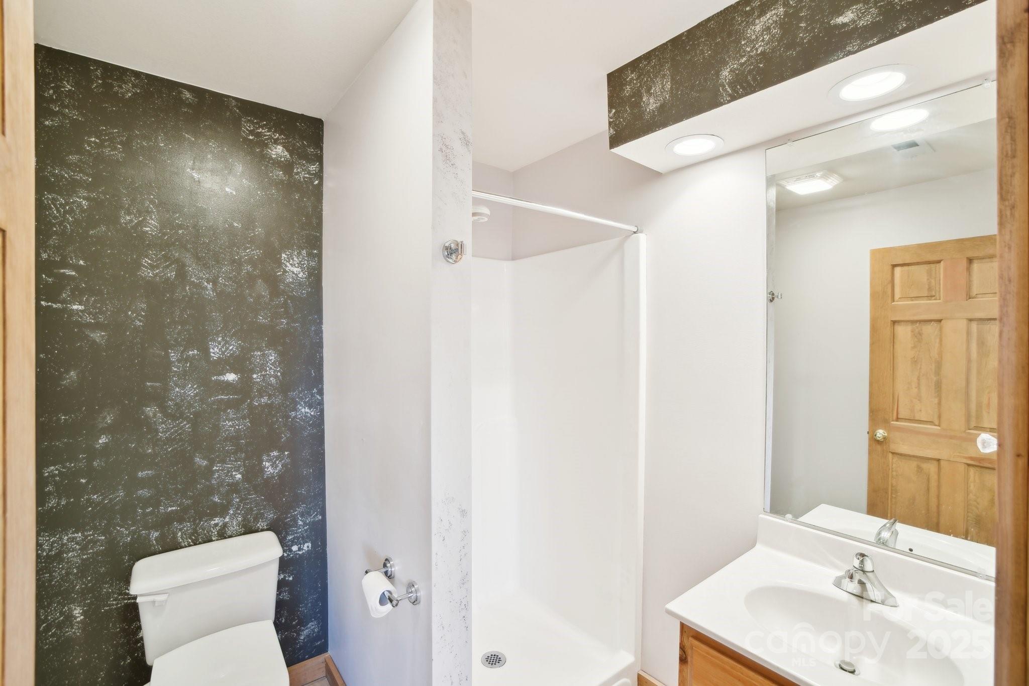 1426 Setzercove Road Maggie Valley, NC 28751 - Photo 27 of 48 a bathroom with a sink toilet and shower