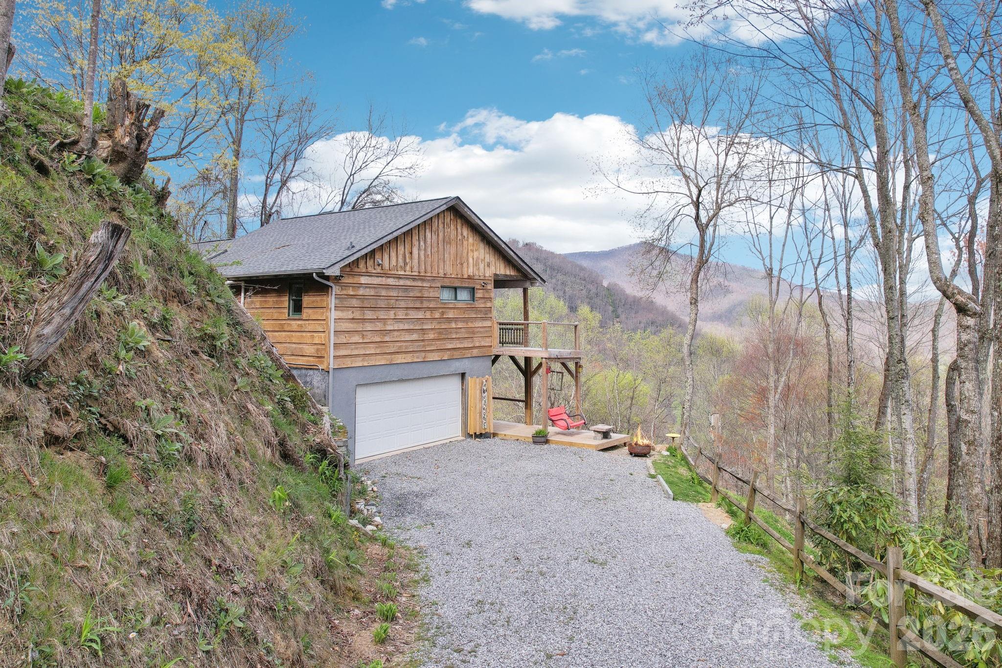 1426 Setzercove Road Maggie Valley, NC 28751 - Photo 31 of 48 a view of a house with a yard and pathway