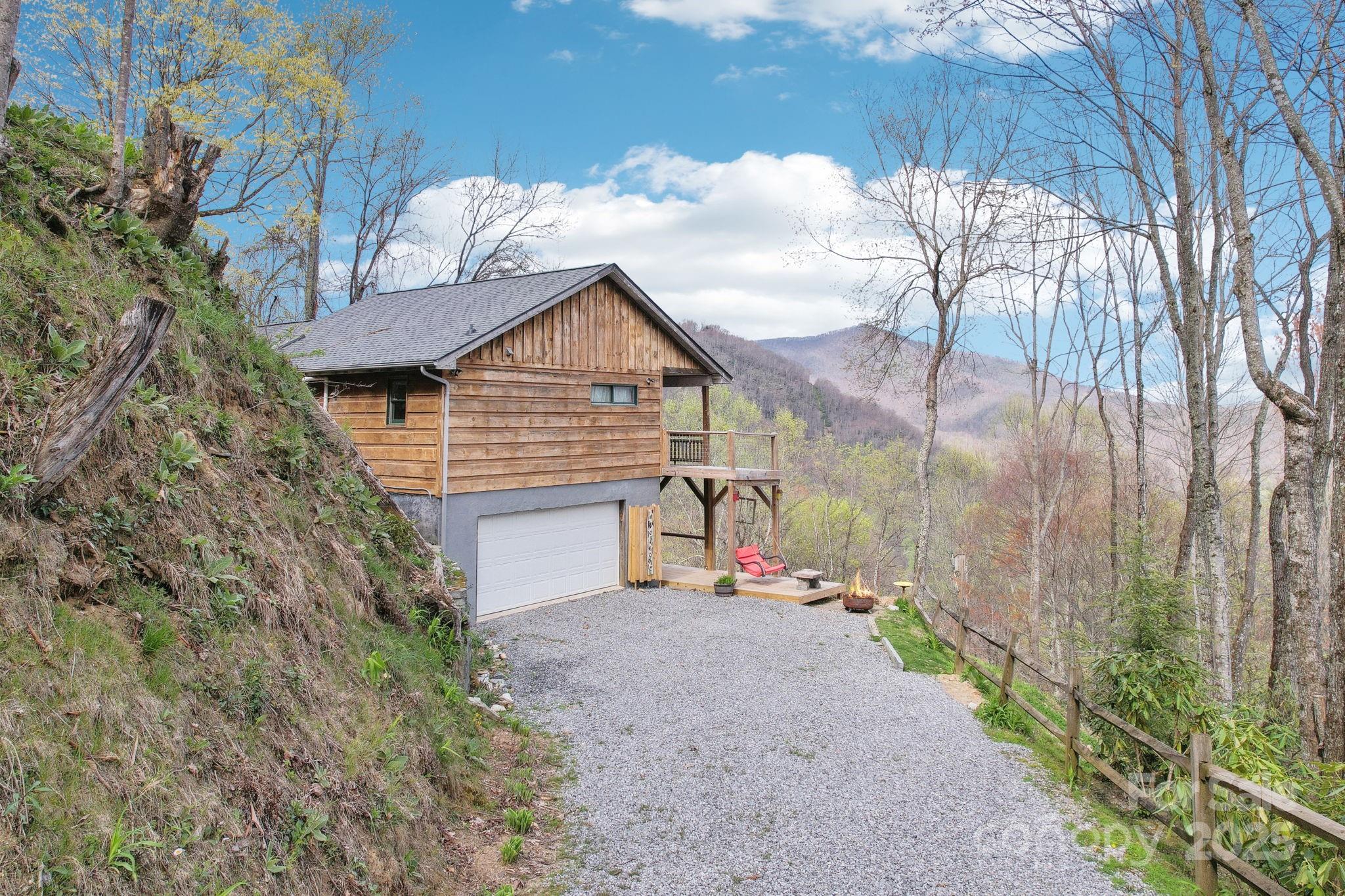 1426 Setzercove Road Maggie Valley, NC 28751 - Photo 6 of 48 a view of a house with a yard and pathway
