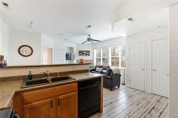 a kitchen with stainless steel appliances granite countertop a stove and white cabinets with wooden floor
