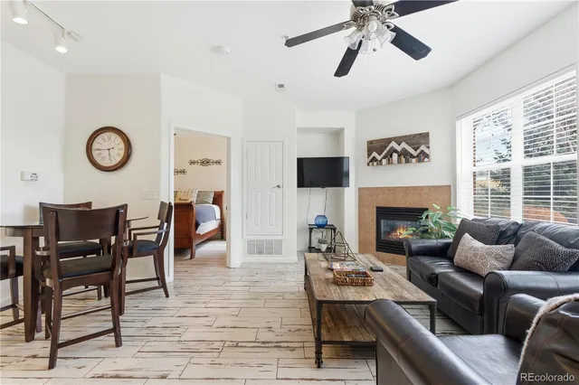 a living room with furniture a clock and a fireplace