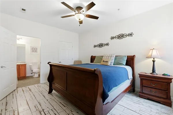 a bedroom with a bed lamp closet and window