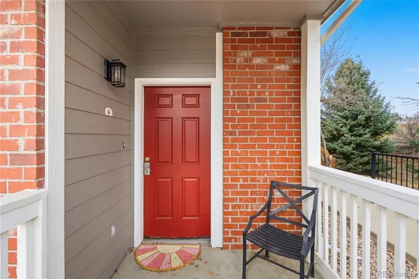 a view of a porch with a table and chairs