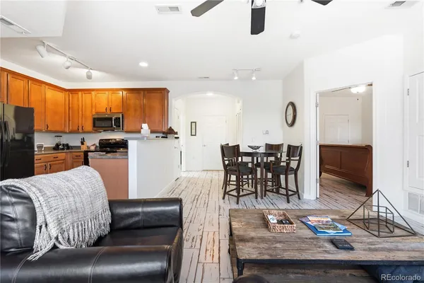 a living room with furniture and wooden floor